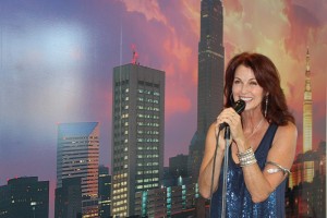 Lorelei Shellist holding microphone, Los Angeles backdrop
